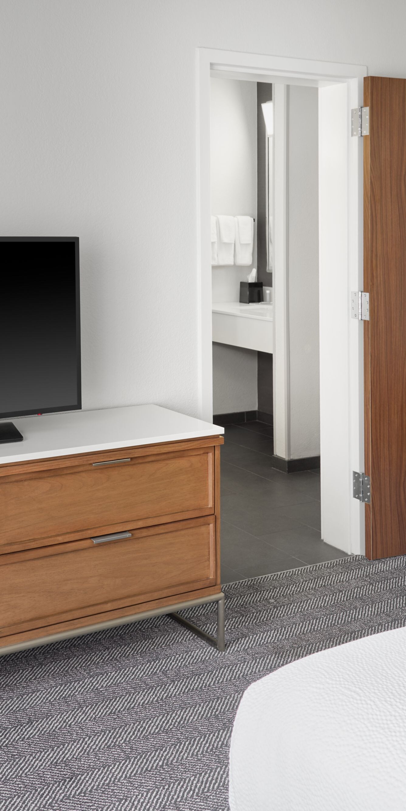 TV on dresser with orange chair