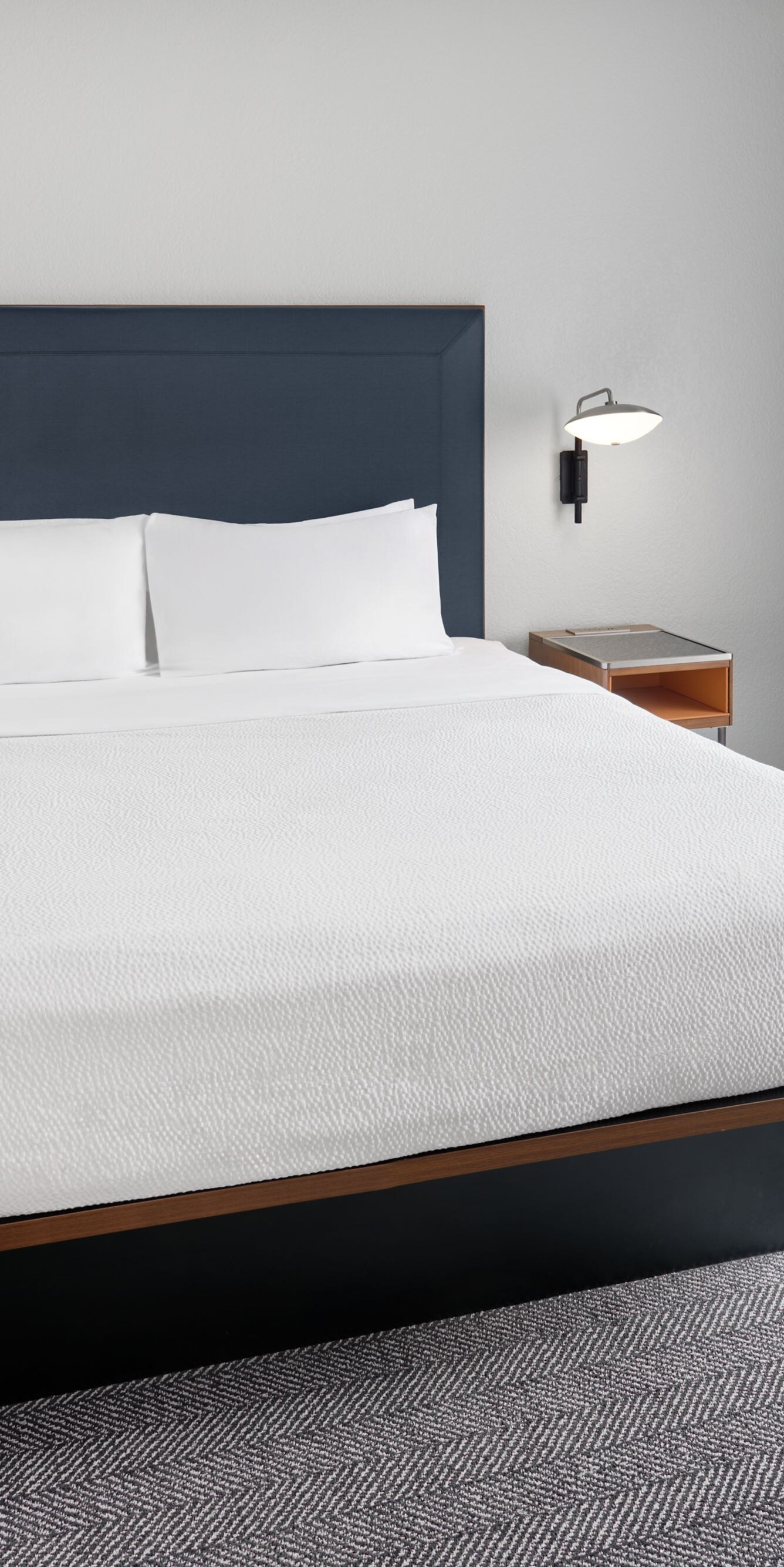 king bed with nightstands next to a window