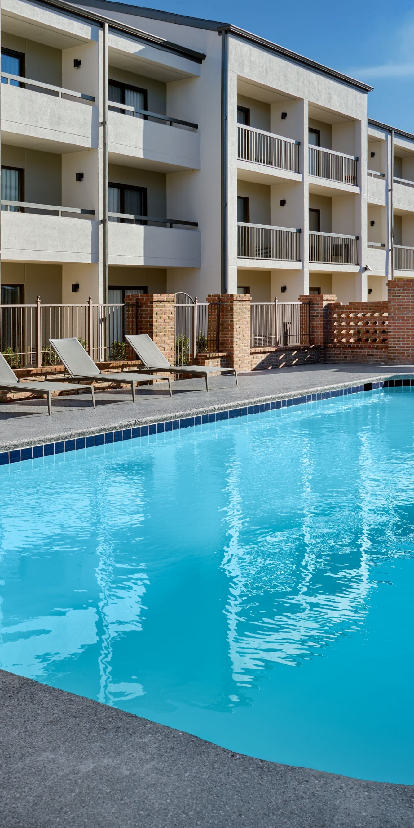 Outdoor pool at daytime with sun loungers
