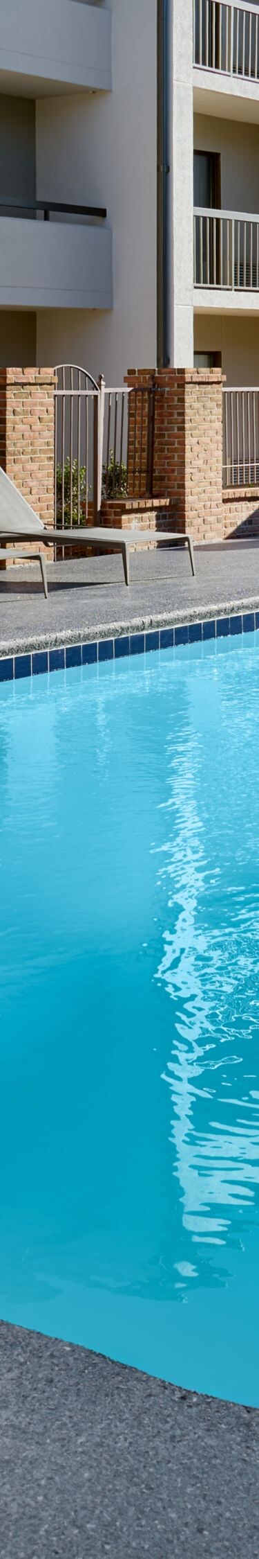 Outdoor pool at daytime with sun loungers