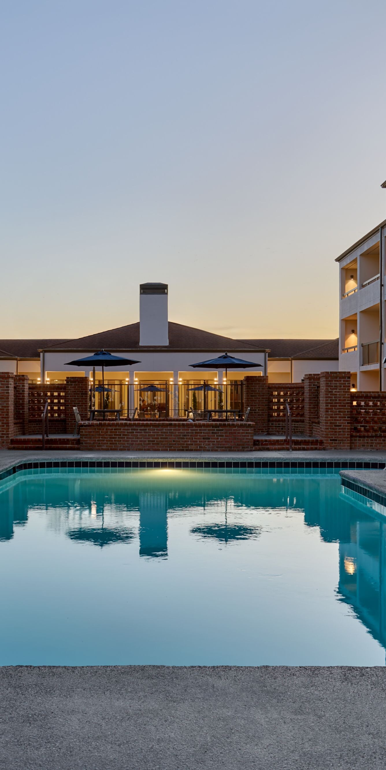 Pool with lounge chairs at dusk