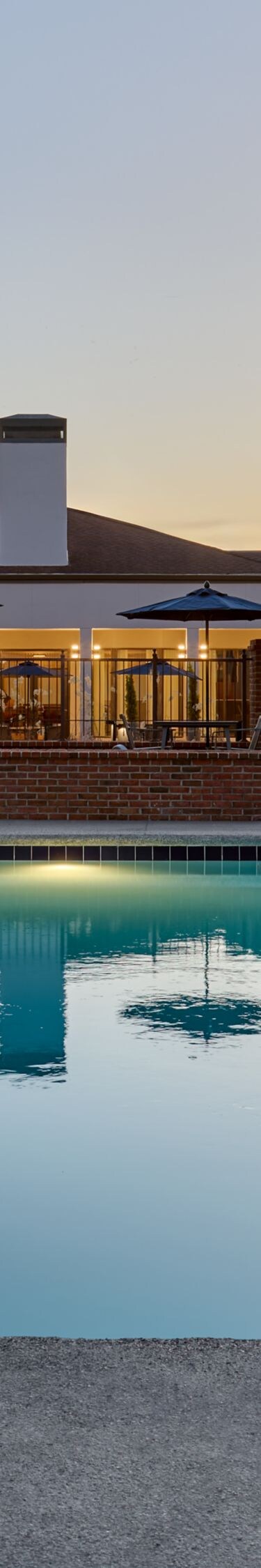 Pool with lounge chairs at dusk