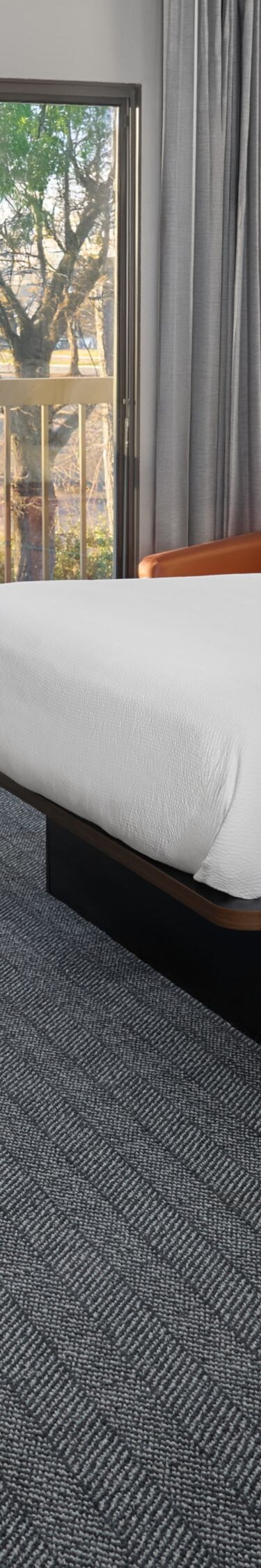 Two queen beds with desk, chair, and balcony view