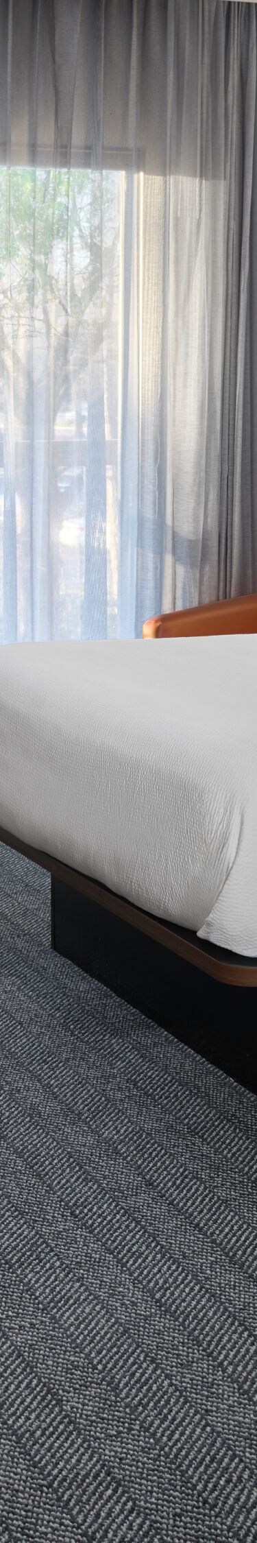 Two queen beds with desk and chair by window