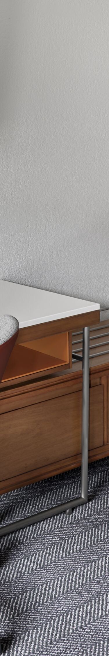 Desk with chair, wall TV, and kitchenette area