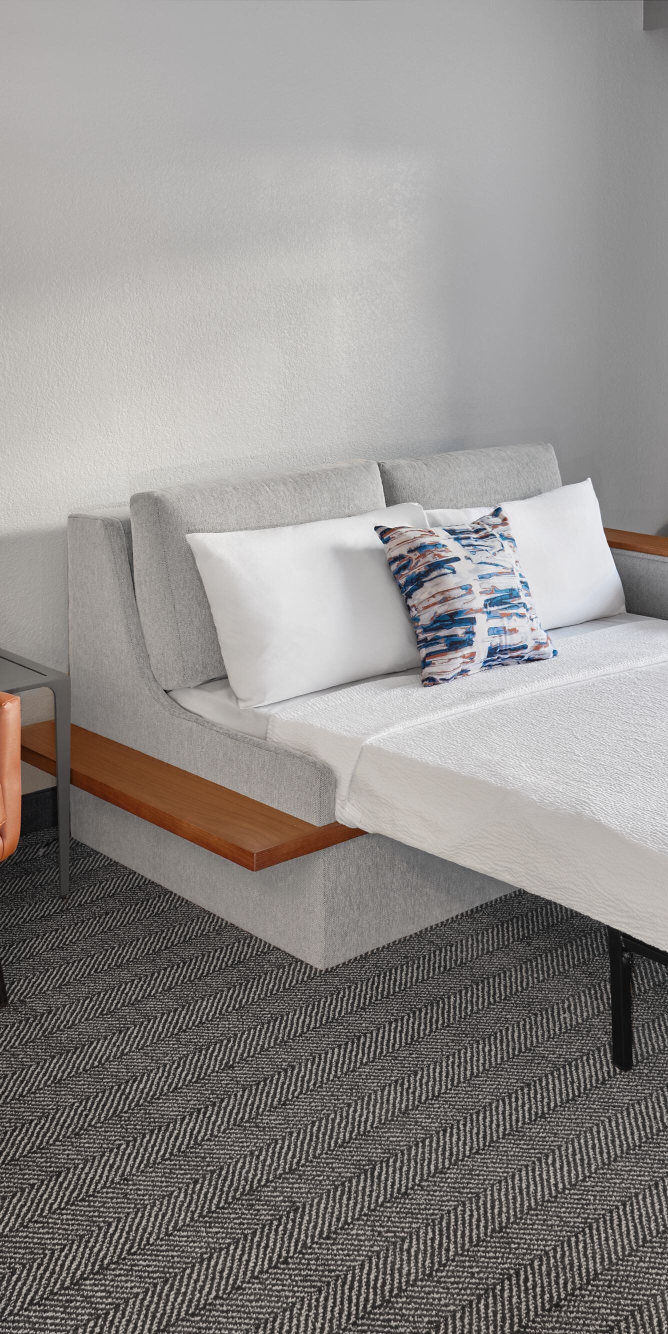 orange armchair next to sofa bed