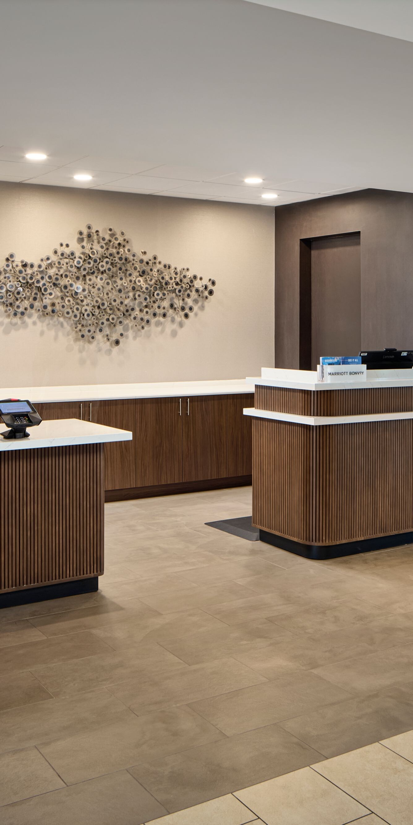 Hotel front desk with seating area nearby