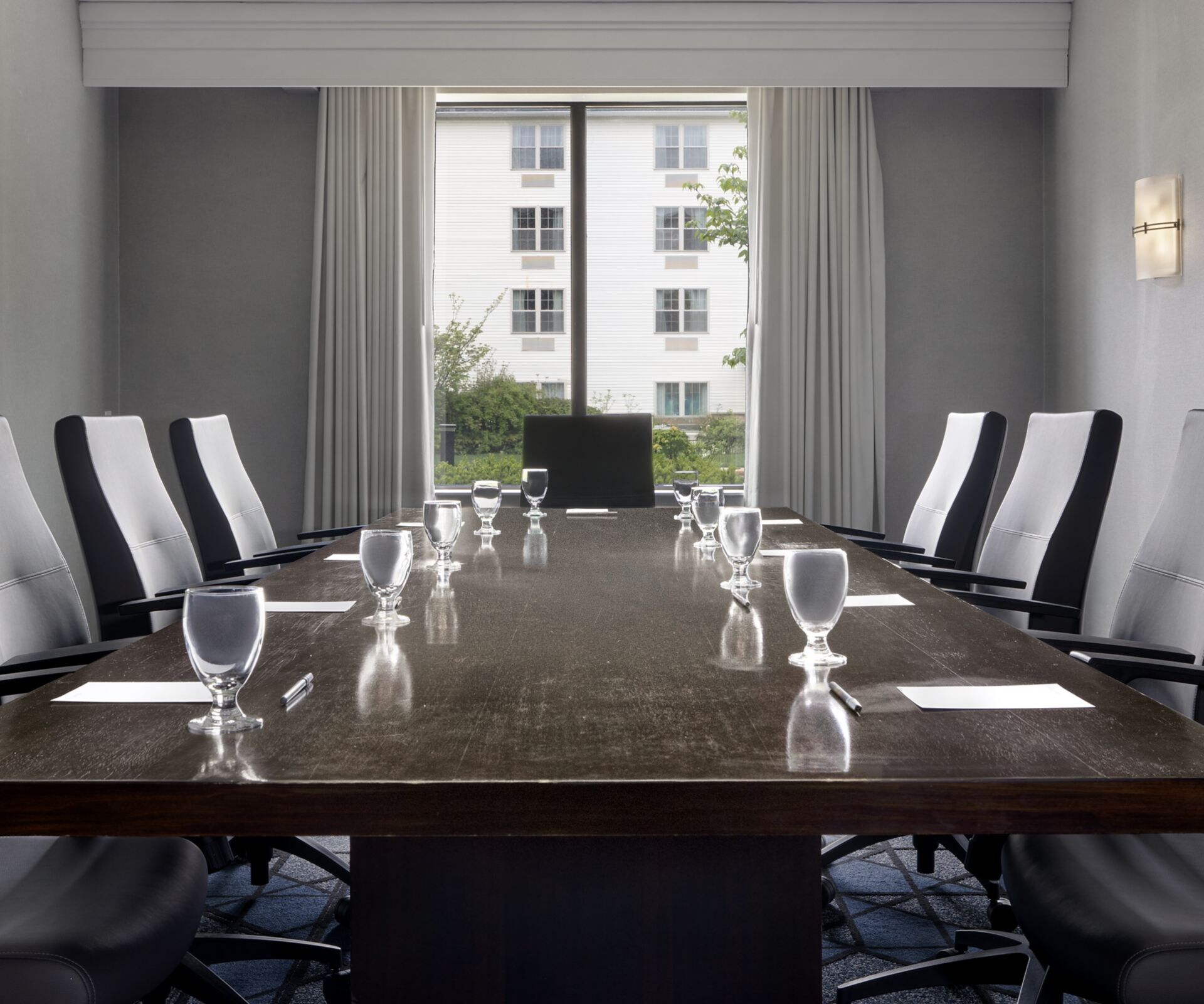 Boardroom with large conference table and chairs.