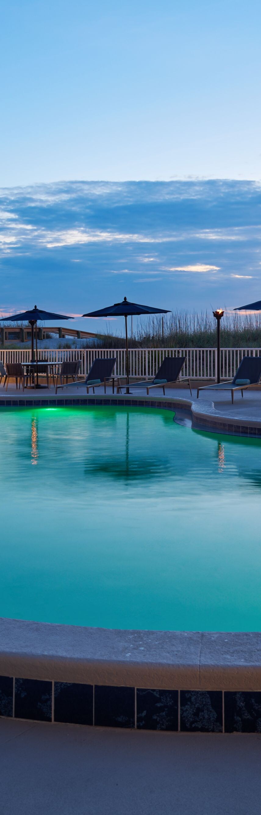 outdoor swimming pool, lounge chairs and umbrellas