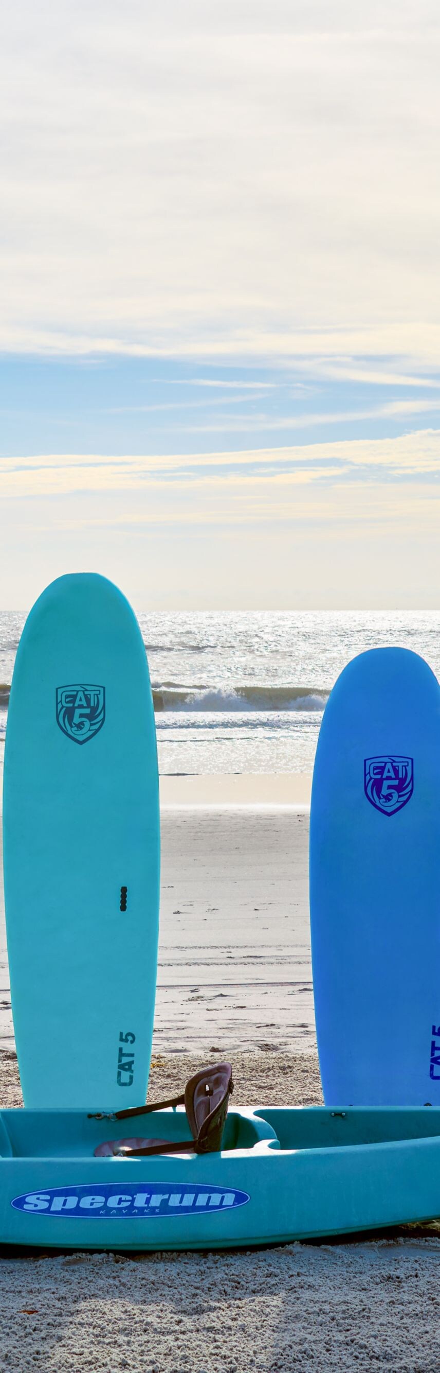 surfboards, kayaks and bikes on beach