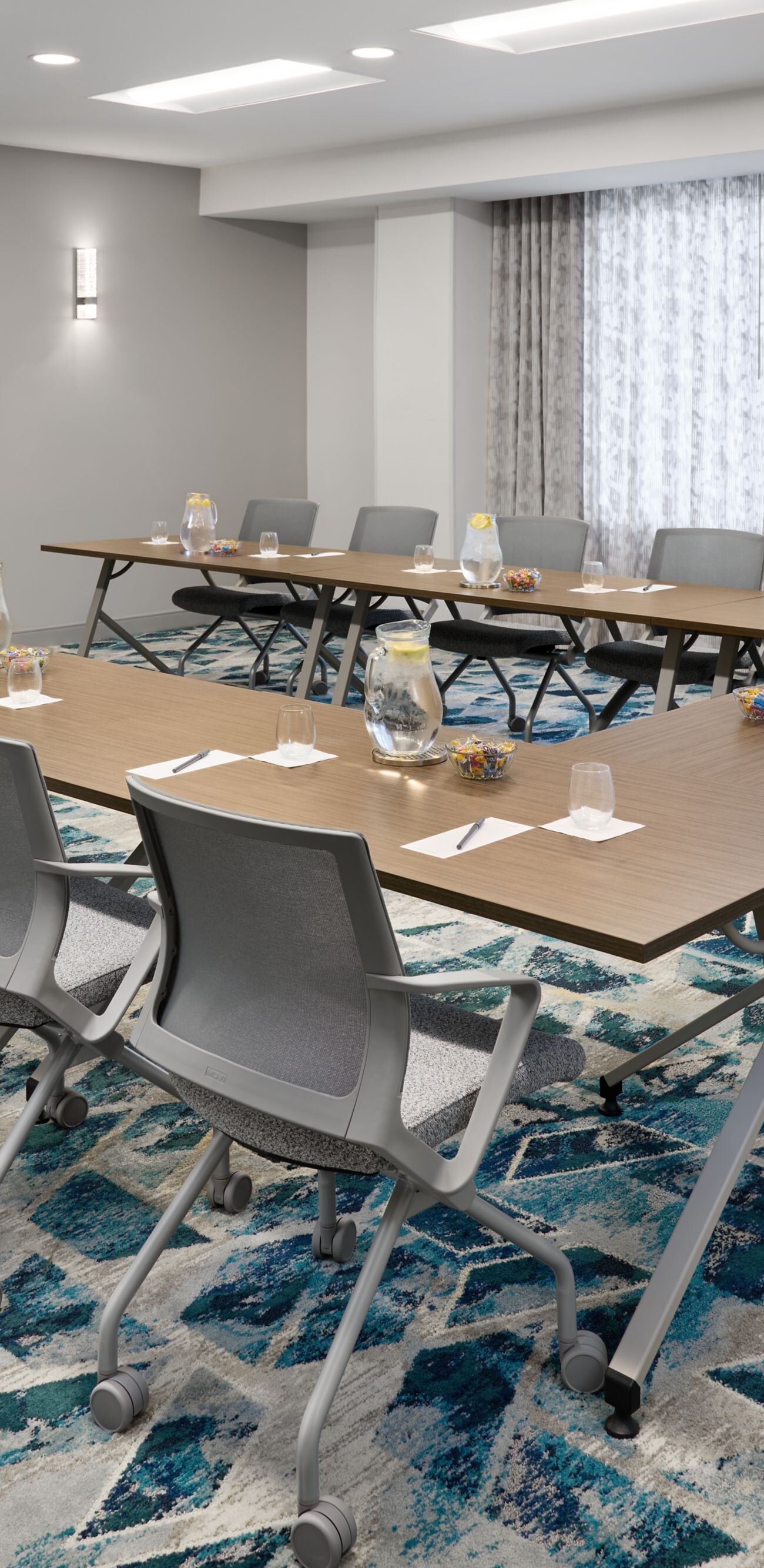 boardroom with a u-shape table, chairs and tv