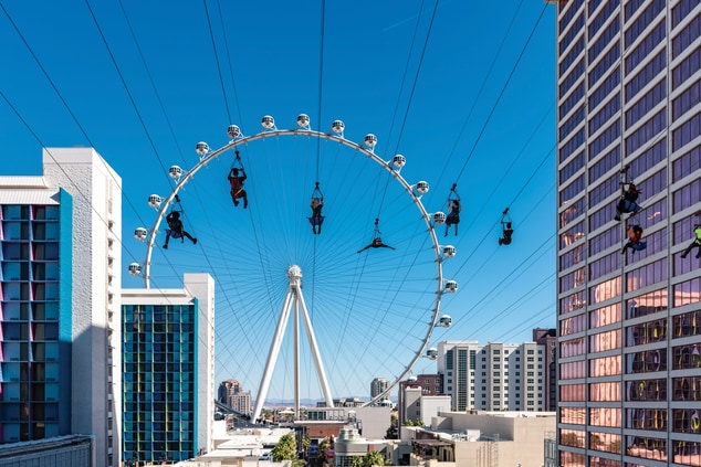 Zipline attraction with people soaring in the sky