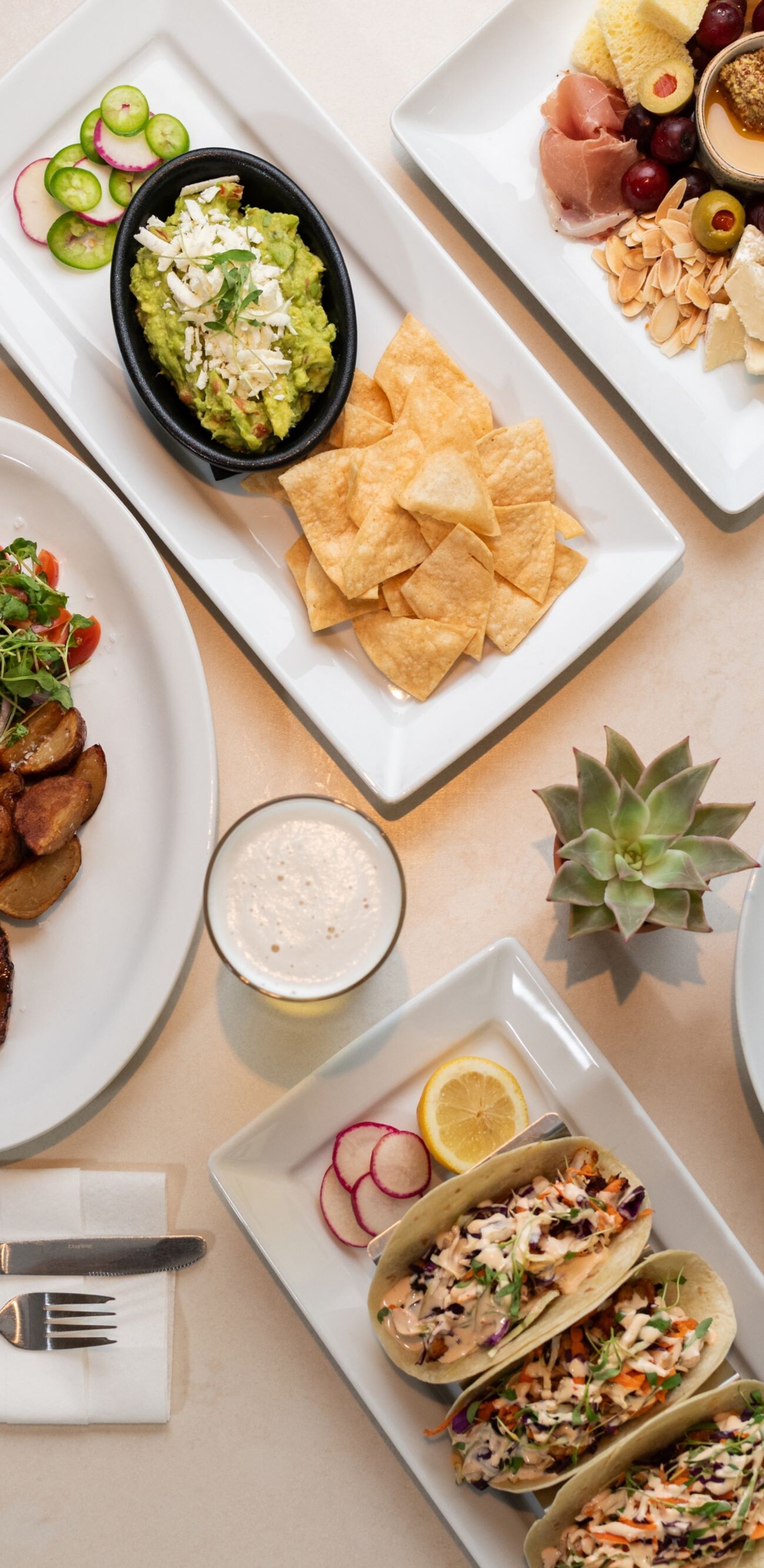 Gourmet spread with steak, tacos, and soup