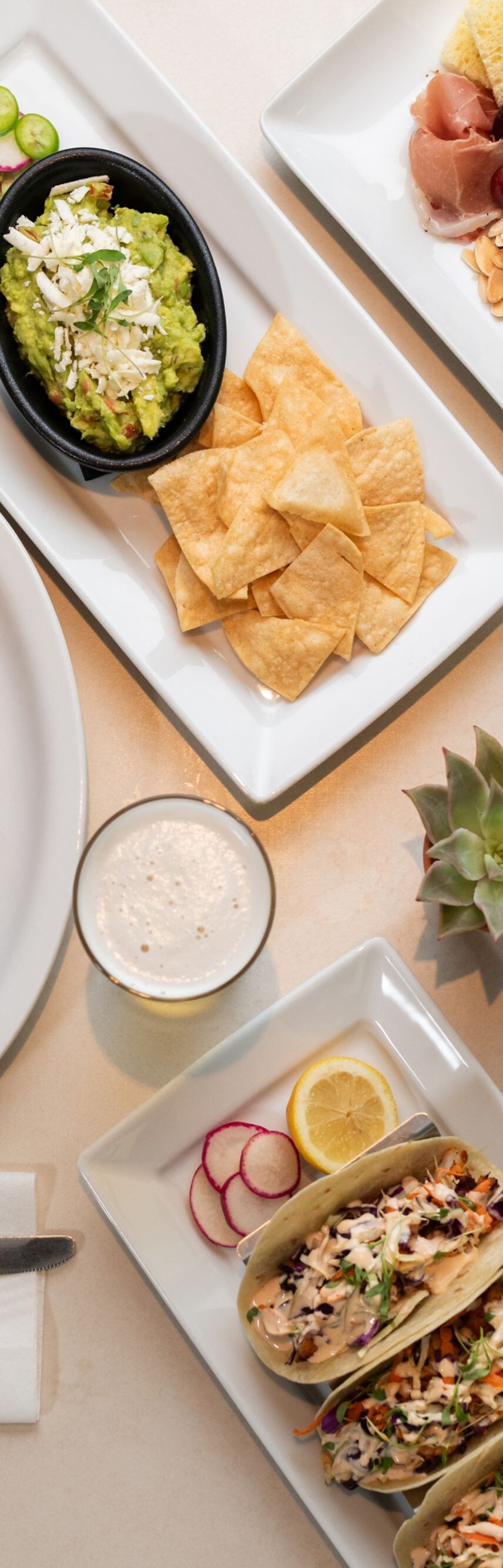 Gourmet spread with steak, tacos, and soup