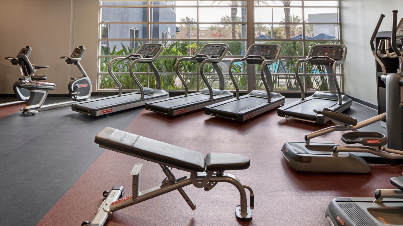 Spacious fitness center overlooking the pool deck