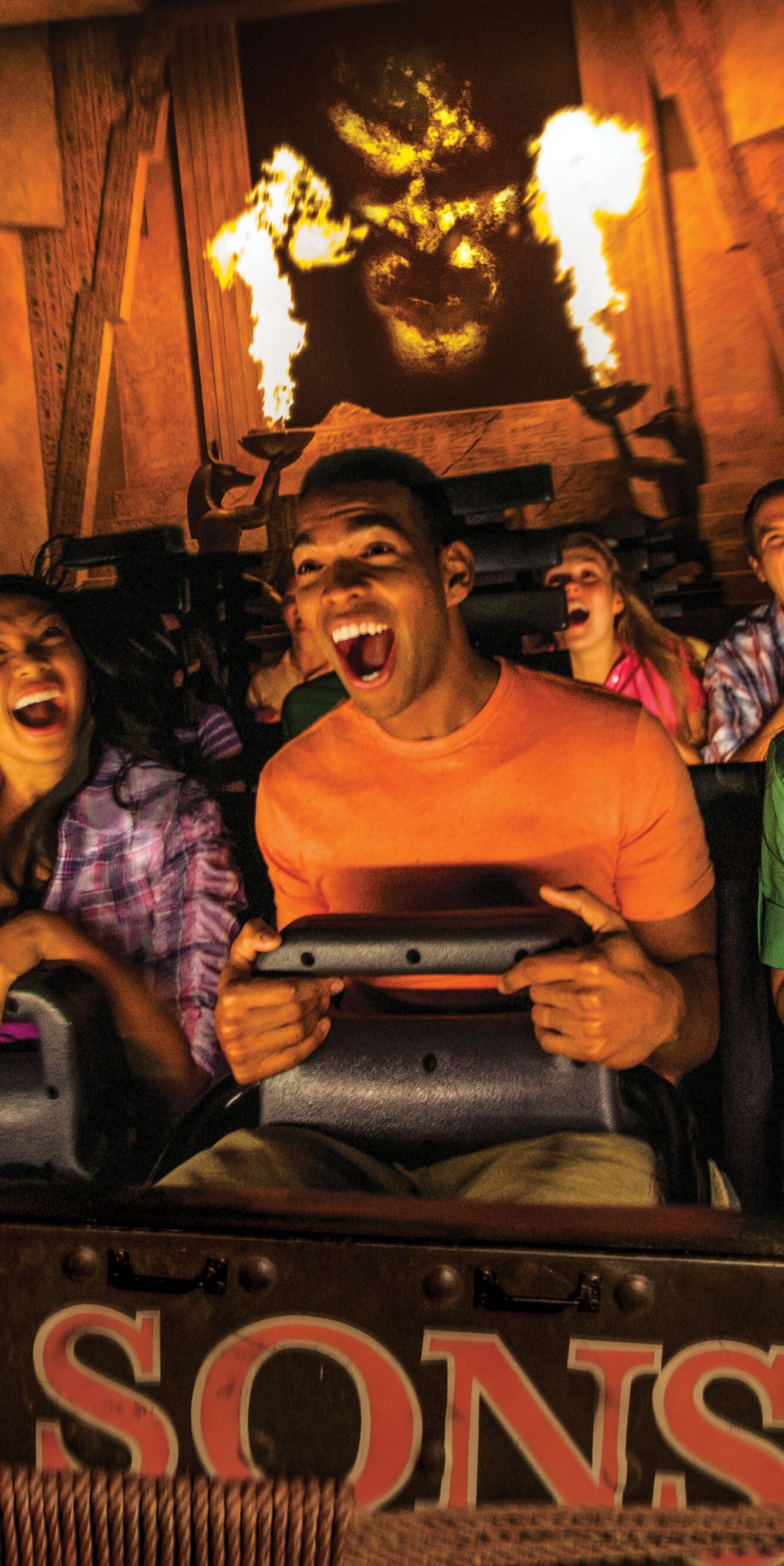 Group on indoor theme park ride with fire