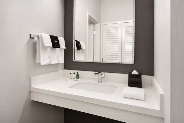 Vanity area with towels and bath amenities