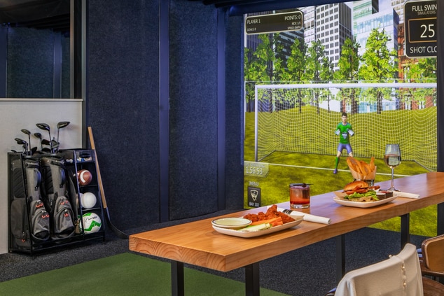 Topgolf Soccer with seating with wings and burger