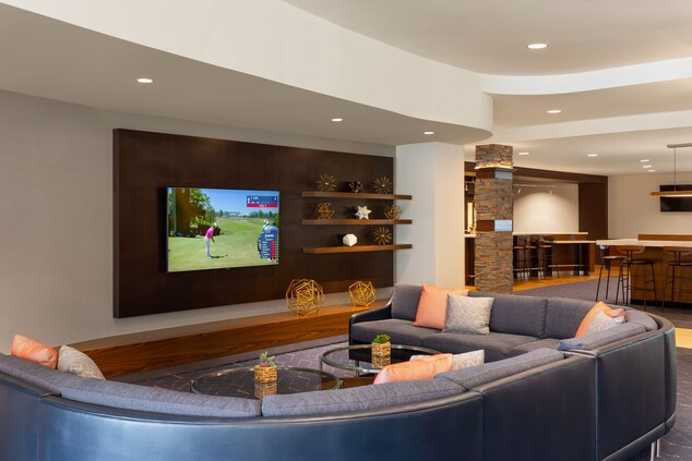 Lobby seating with oversized couch and TV