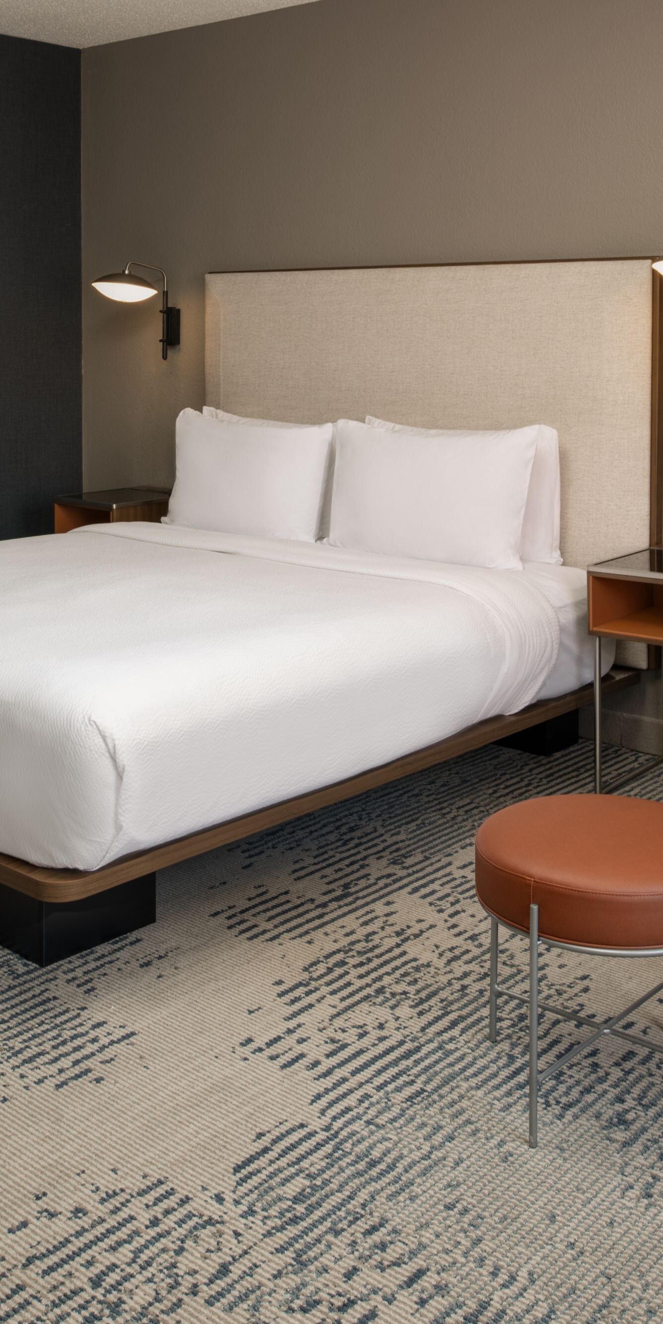 King Bed with orange chair and ottoman