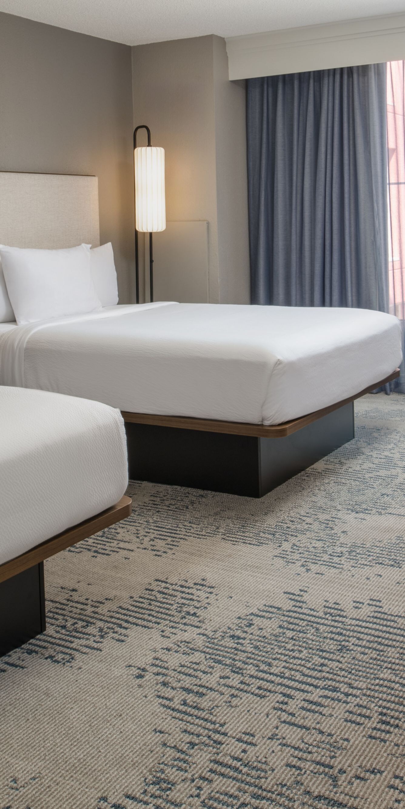 two beds, desk, chair, sitting area