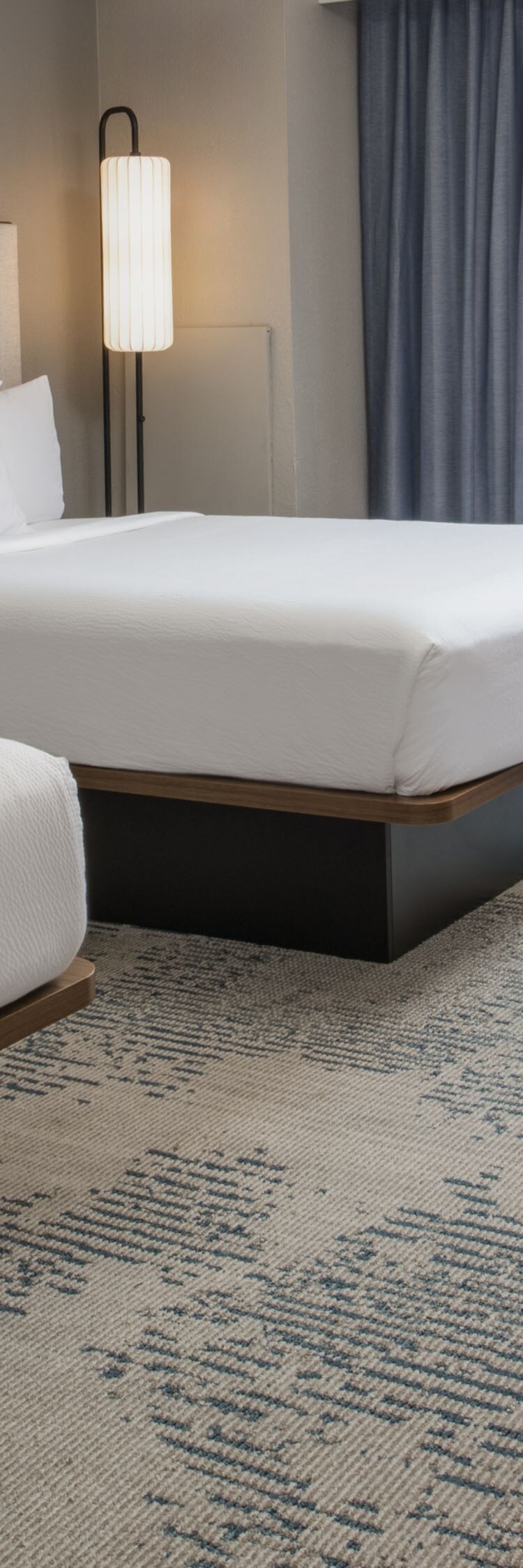 two beds, desk, chair, sitting area