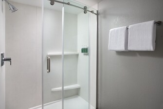bathroom shower with sliding door & bulk toiletry