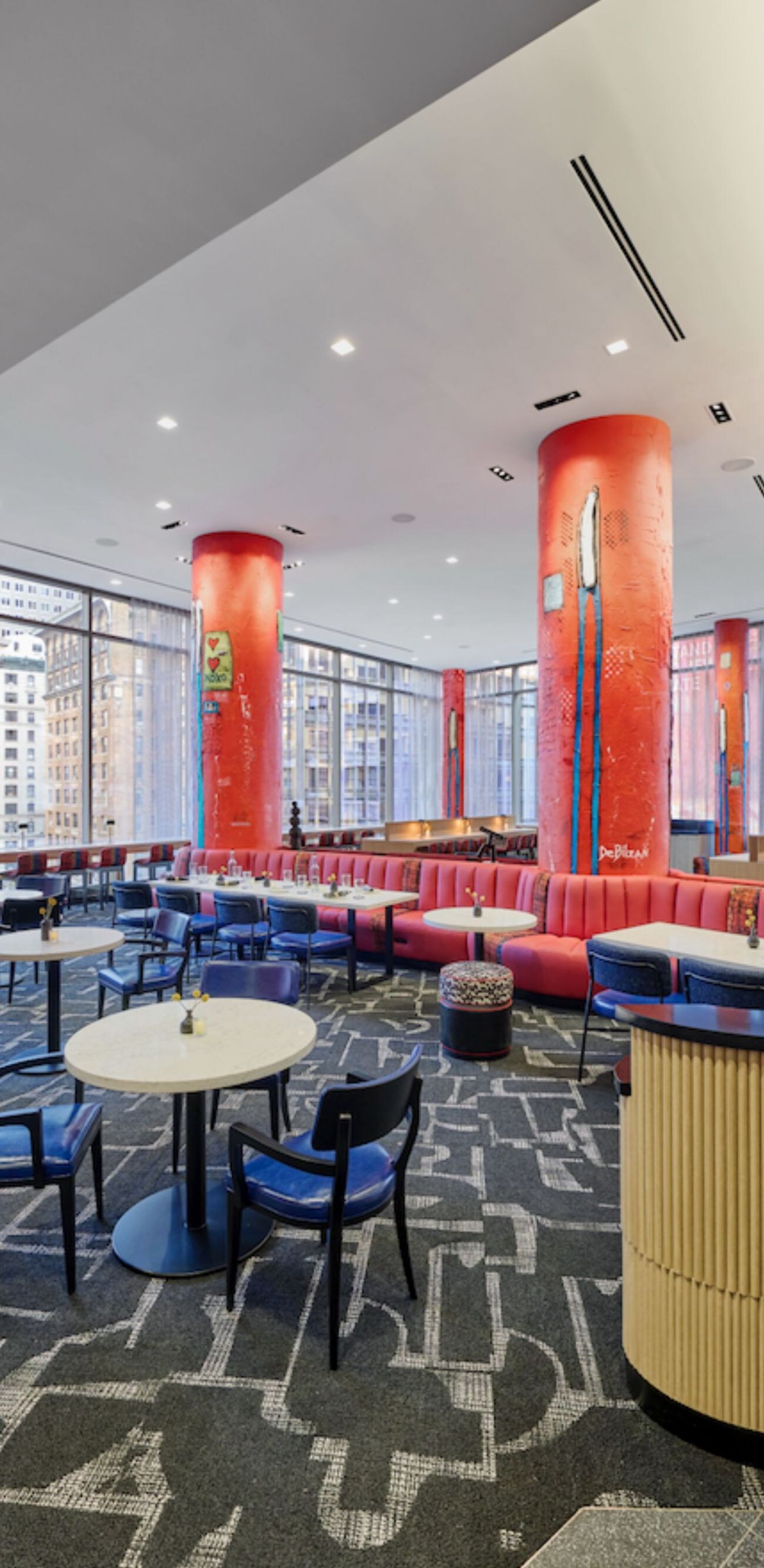 Dining area with red columns and seating