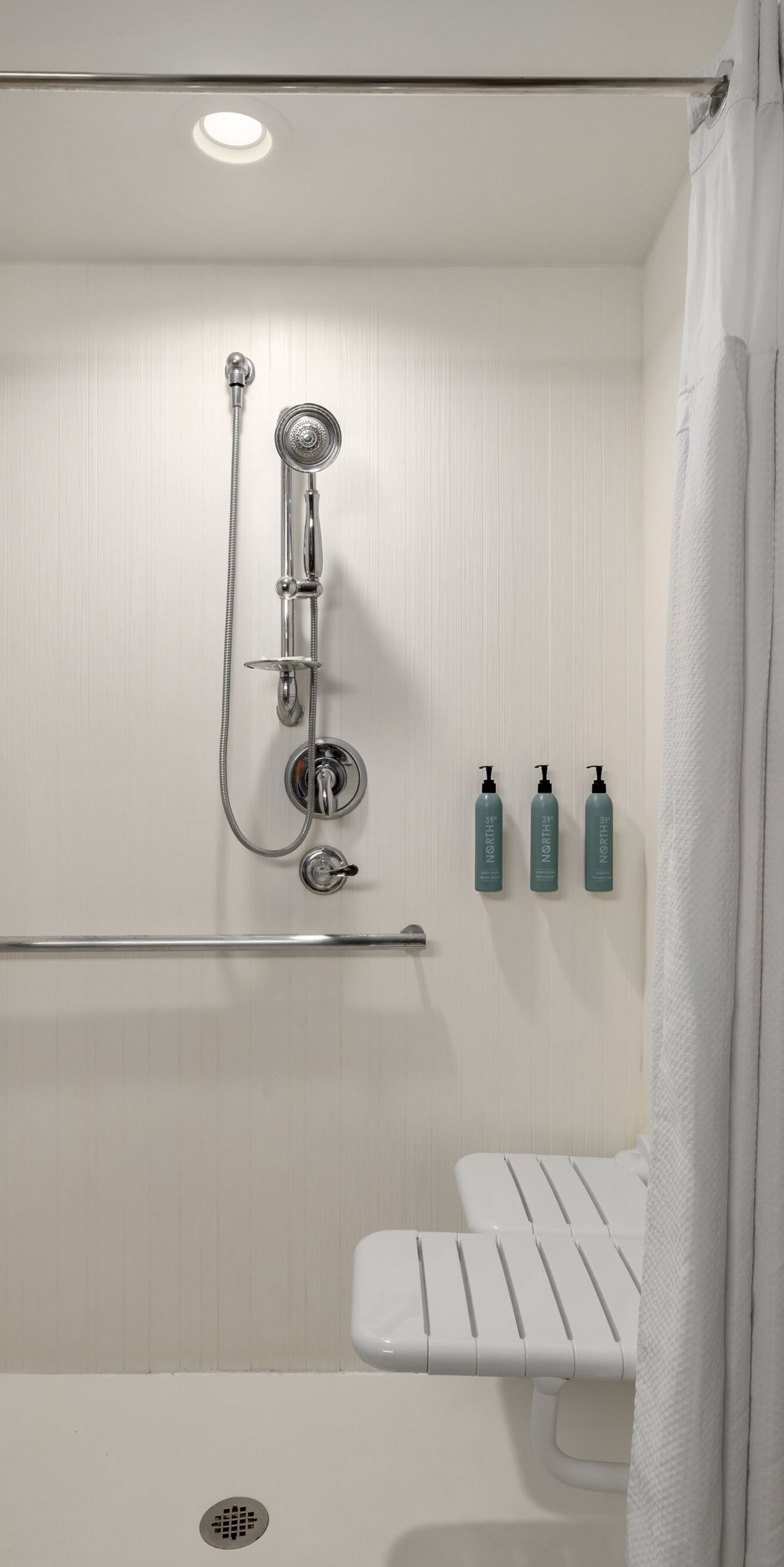 Roll-in shower with grab bars and seat
