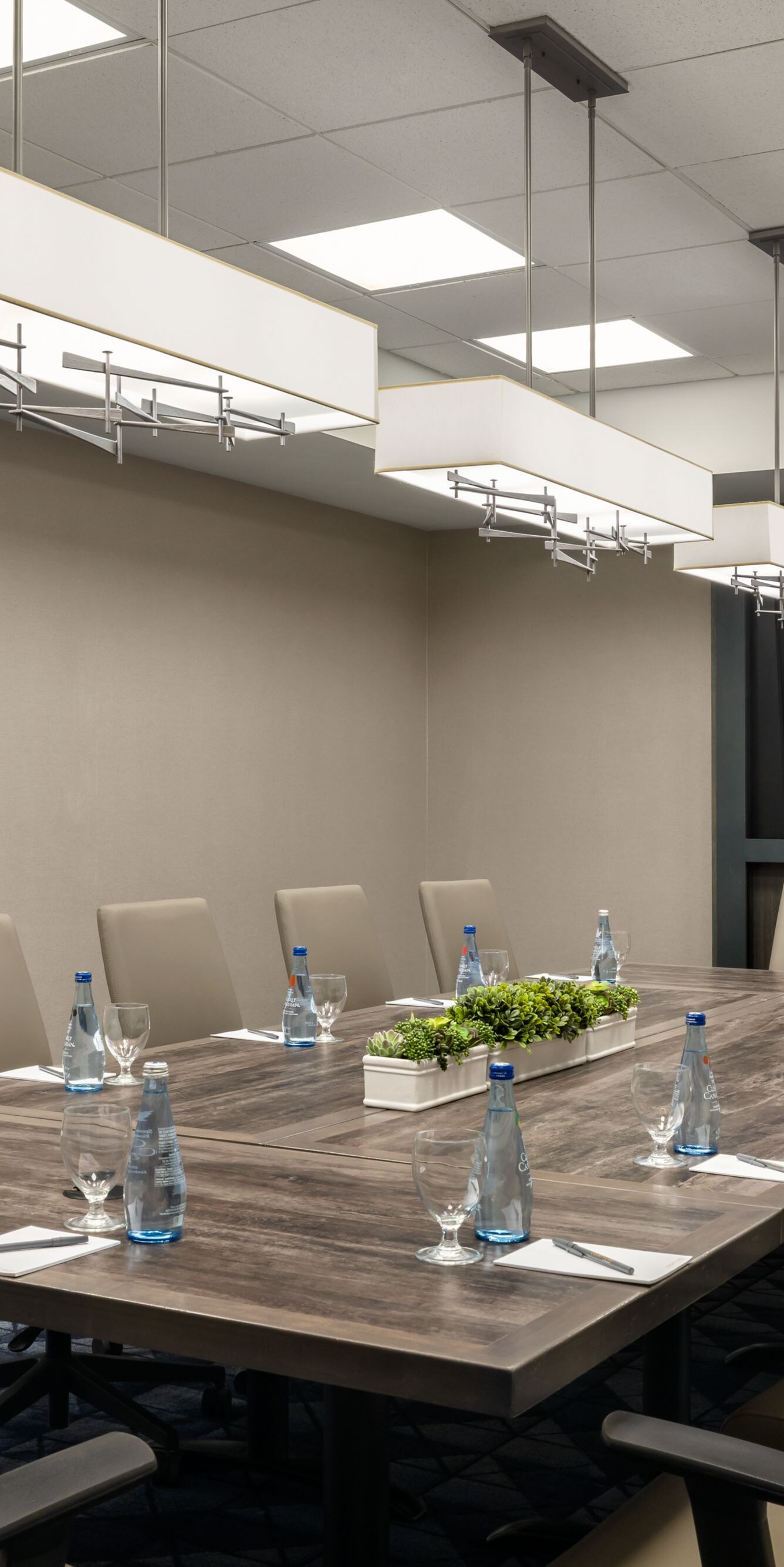 Boardroom with wooden table and flat-screen TV