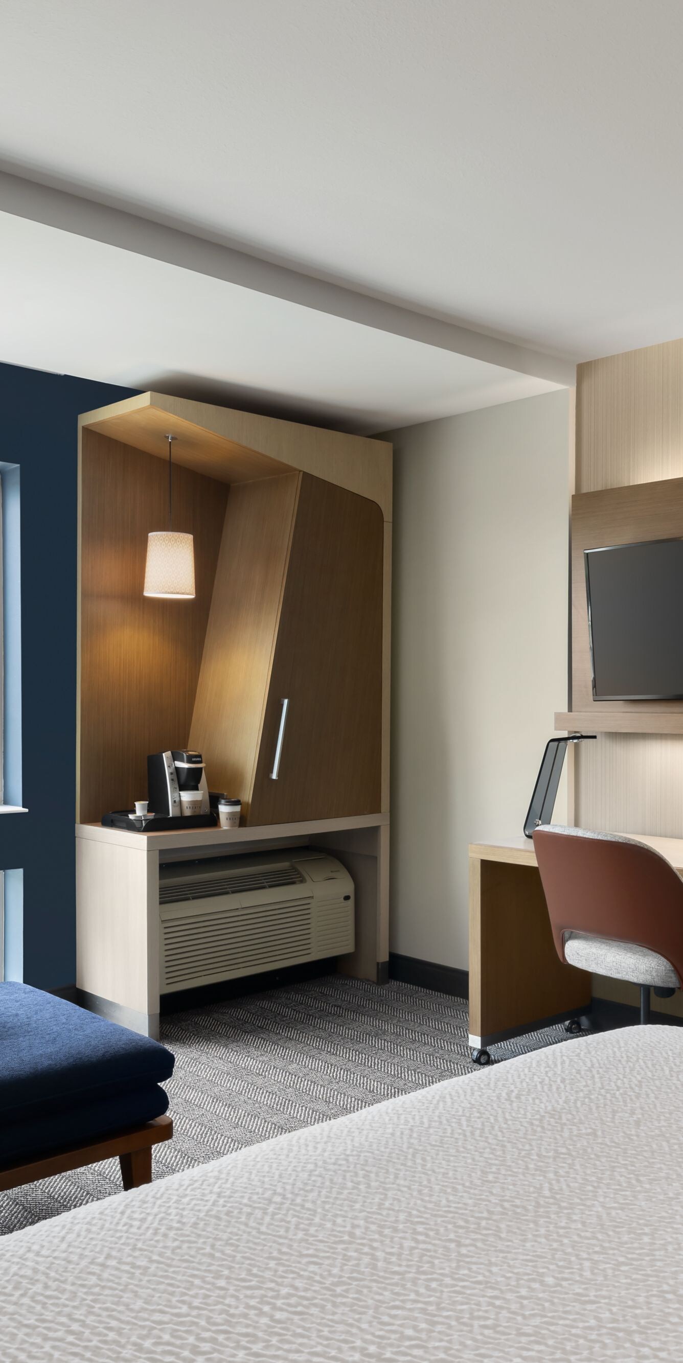 King guest room with sofa and window view