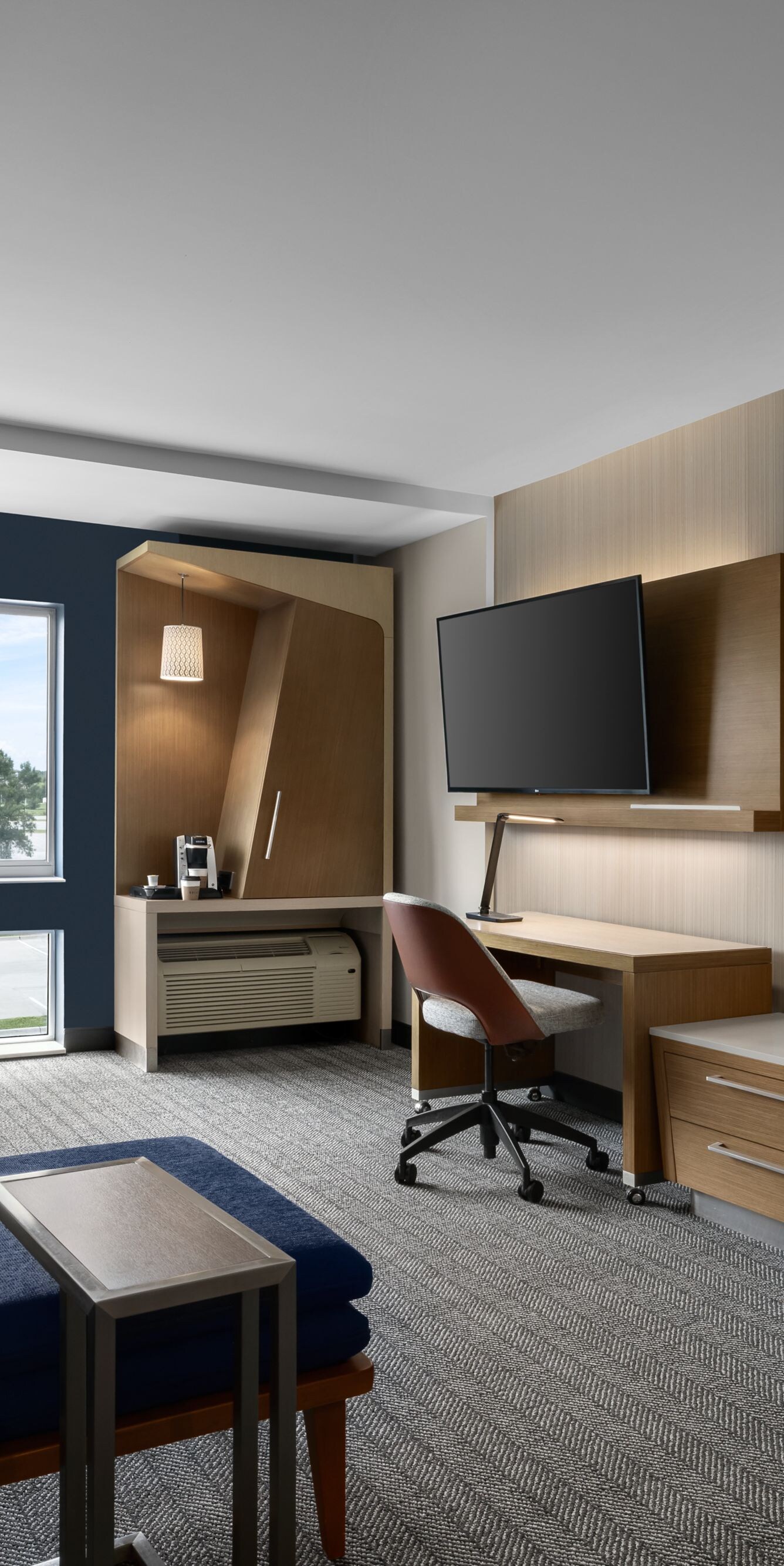 Modern suite living area with desk and sofa