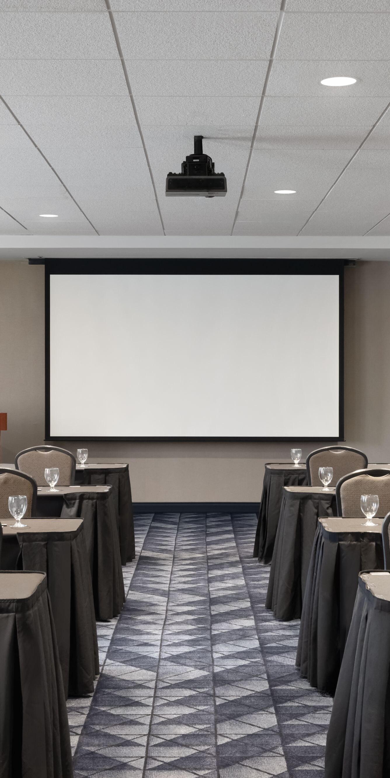Meeting room with classroom setup and screen