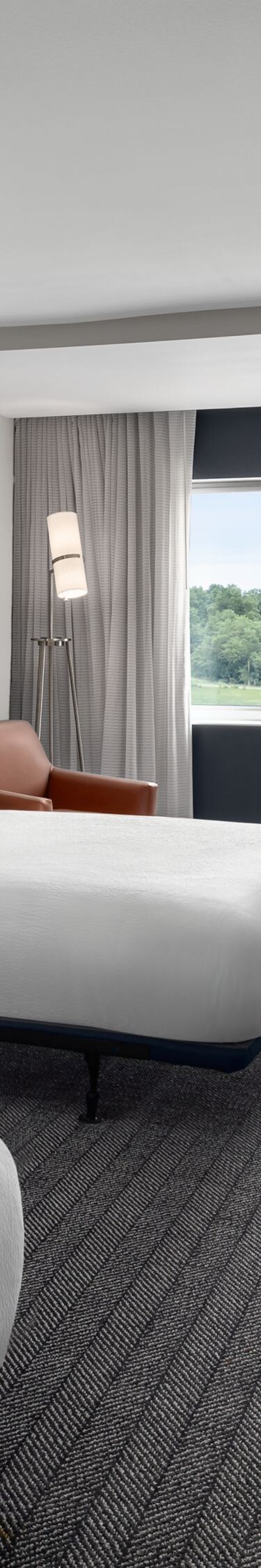 Two queen beds with work desk and window