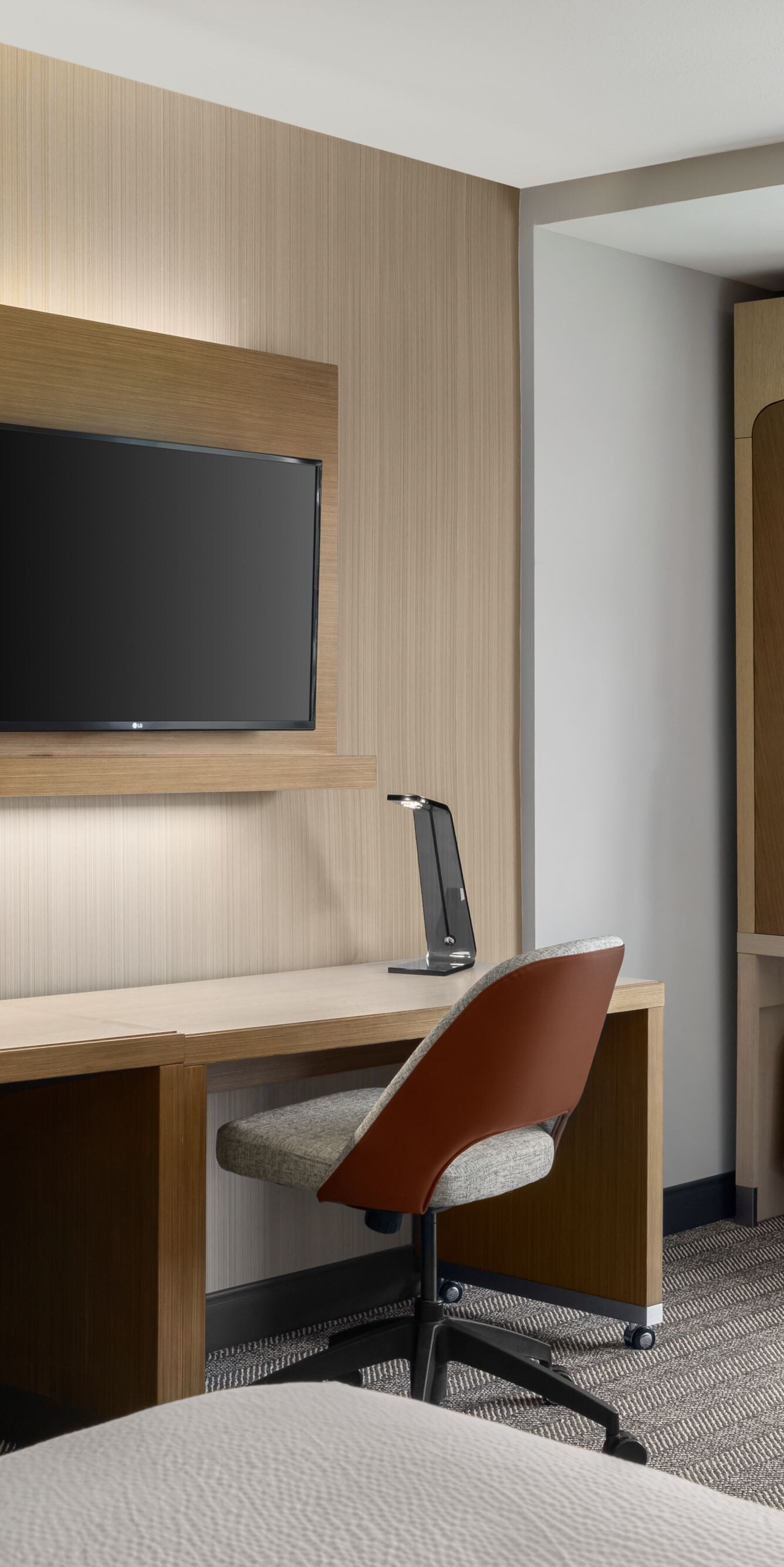 Guest room with work desk and wall-mounted TV