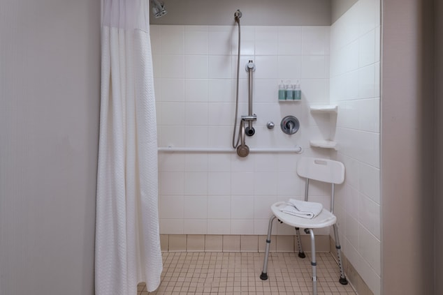 Accessible roll-in shower with shower seat.