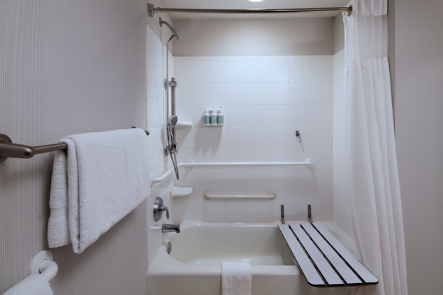 Accessible  bath with grab bars and shower seat.