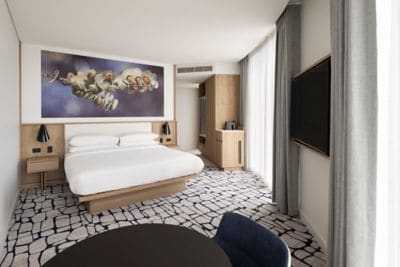 "Room with king bed,  flat-screen TV and desk.