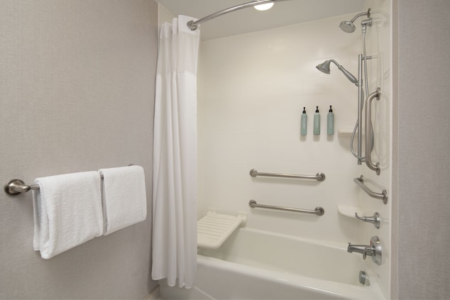 Accessible bathroom with a tub and portable seat