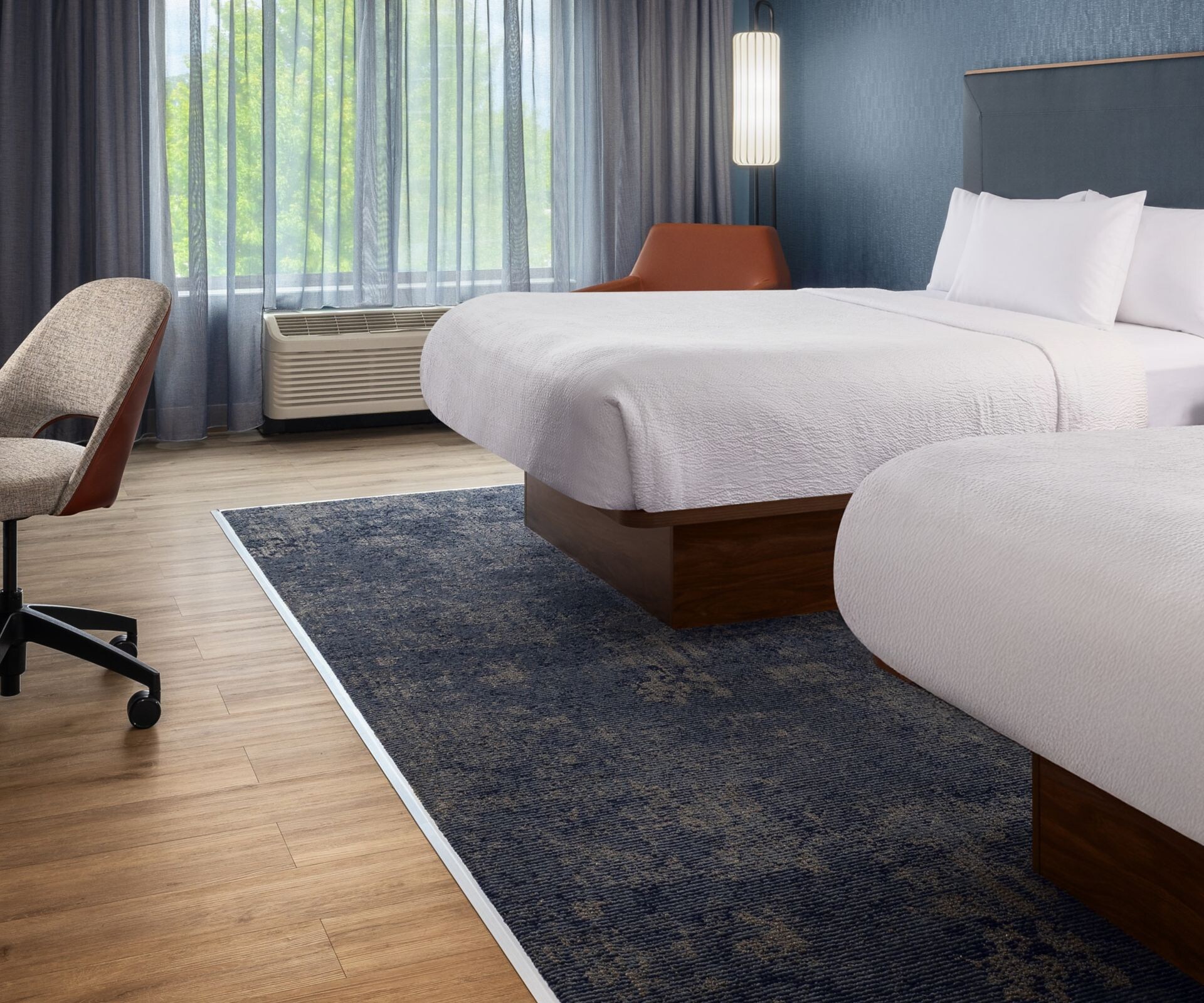 guestroom with two queen beds and work desk
