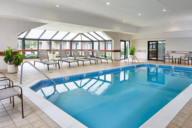 Indoor pool with lounge chairs surrounding