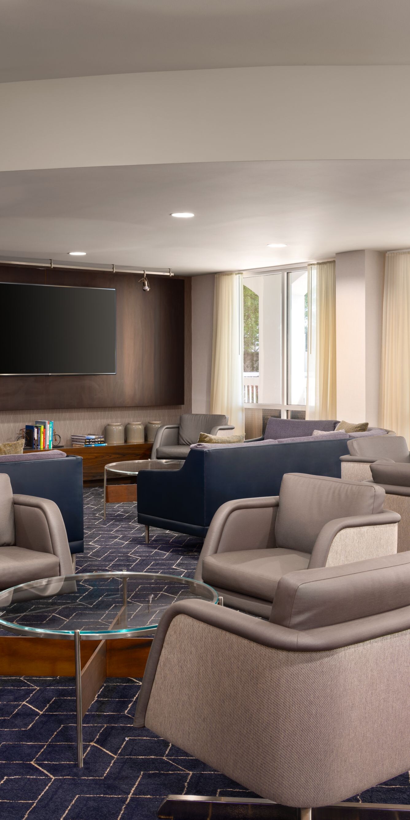 Hotel lounge with chairs and large TV