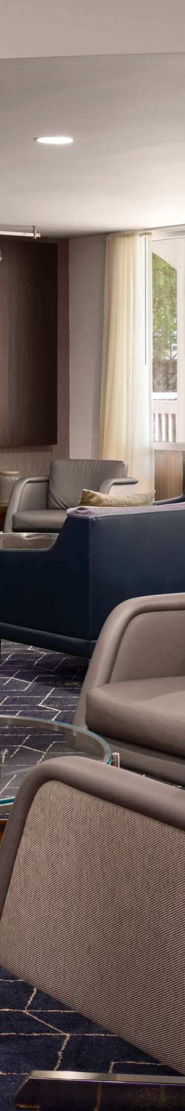 Hotel lounge with chairs and large TV