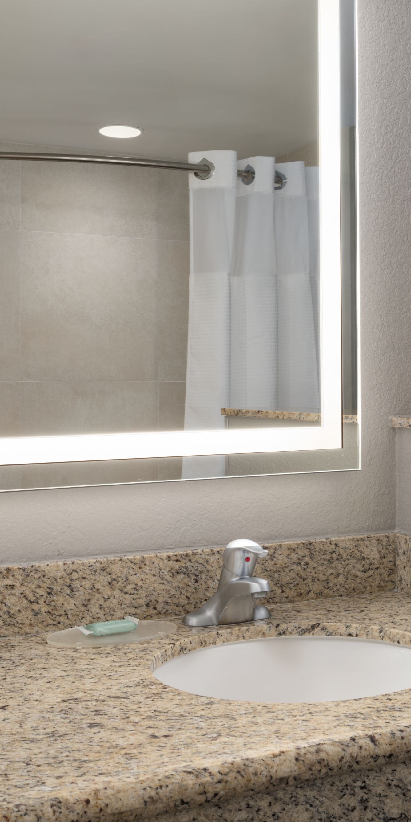 vanity with sink and lighted mirror