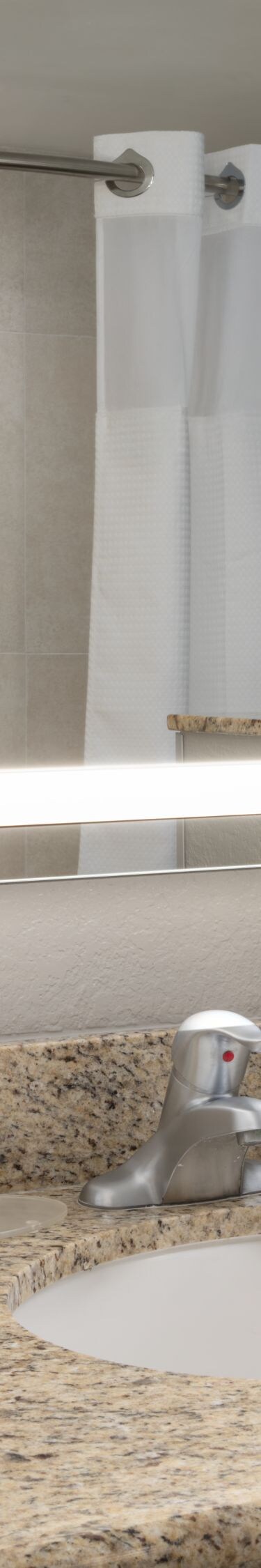 vanity with sink and lighted mirror