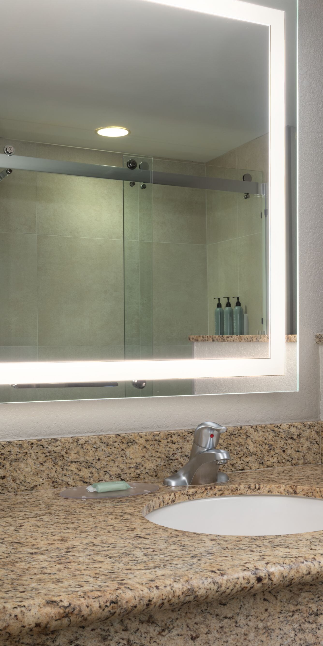 vanity with sink and lighted mirror