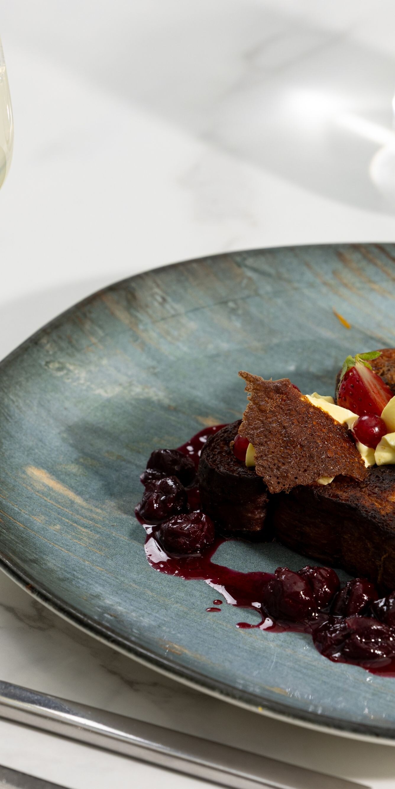 French toast with berries on marble table