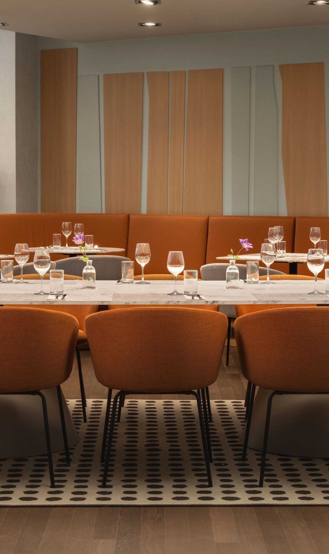 Restaurant with orange chairs and city view