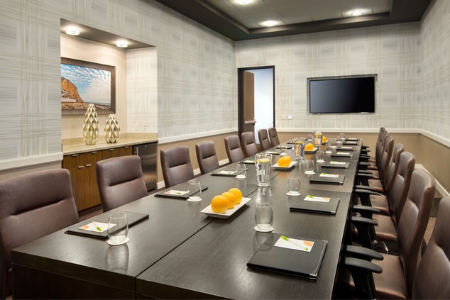 long table, desk chairs, meeting space, television