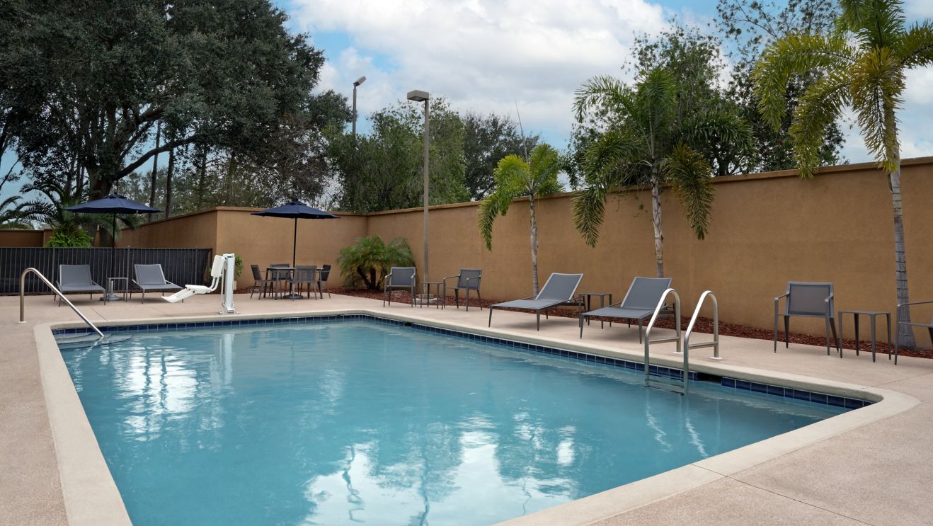 Outdoor pool with accessible lift and pool chairs